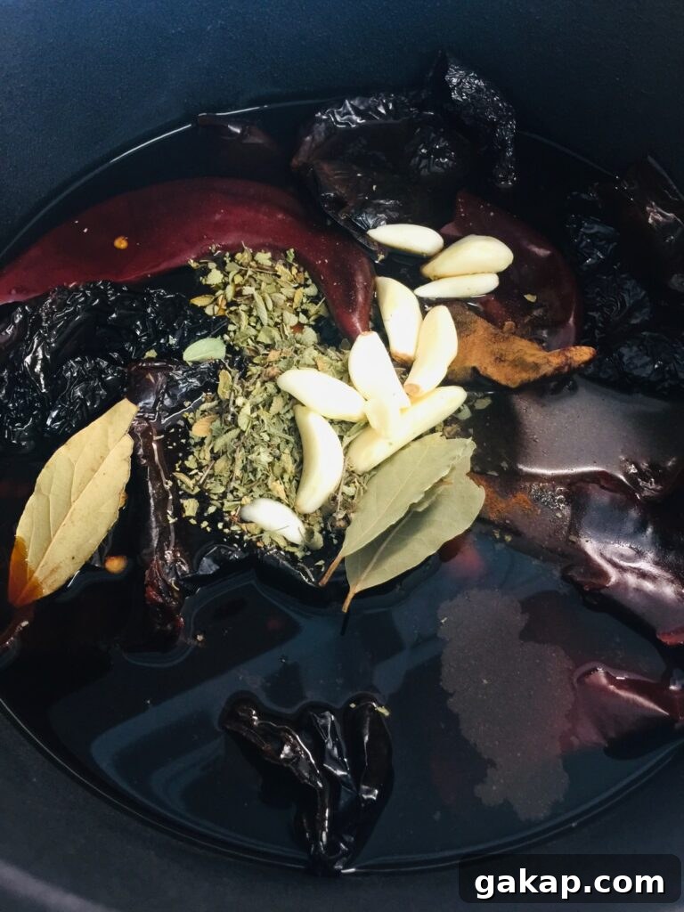 adding garlic and honey to Smoked Chicken Birria