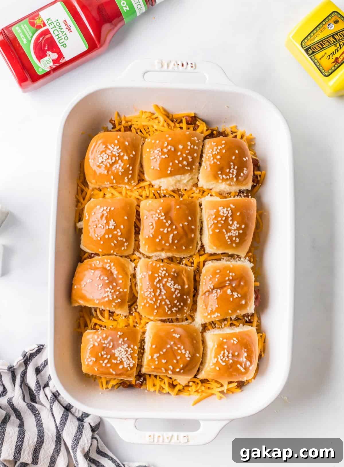 Ground beef sloppy joes on slider buns before baking.