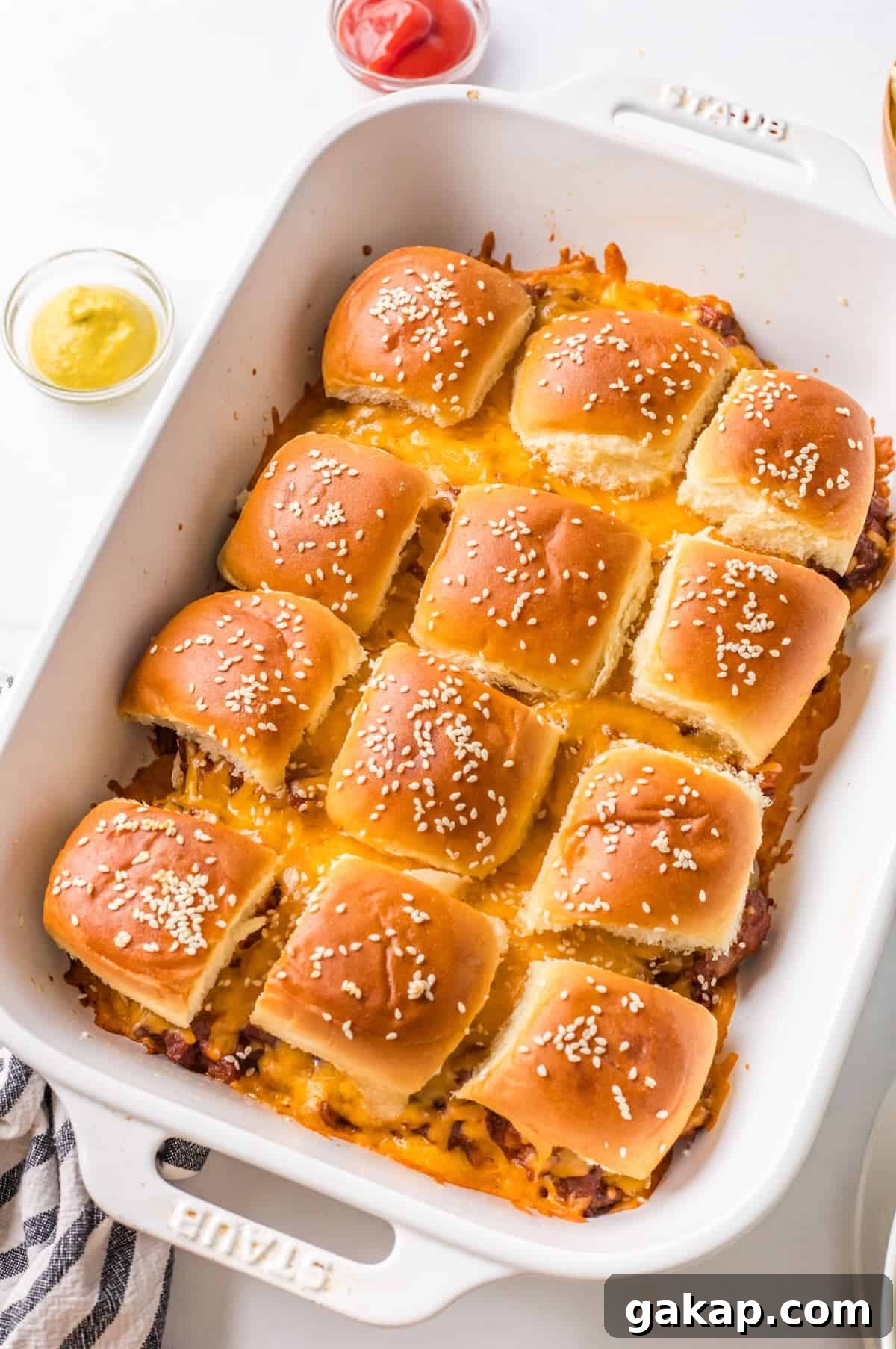 Baked sloppy joe sliders in a casserole pan.