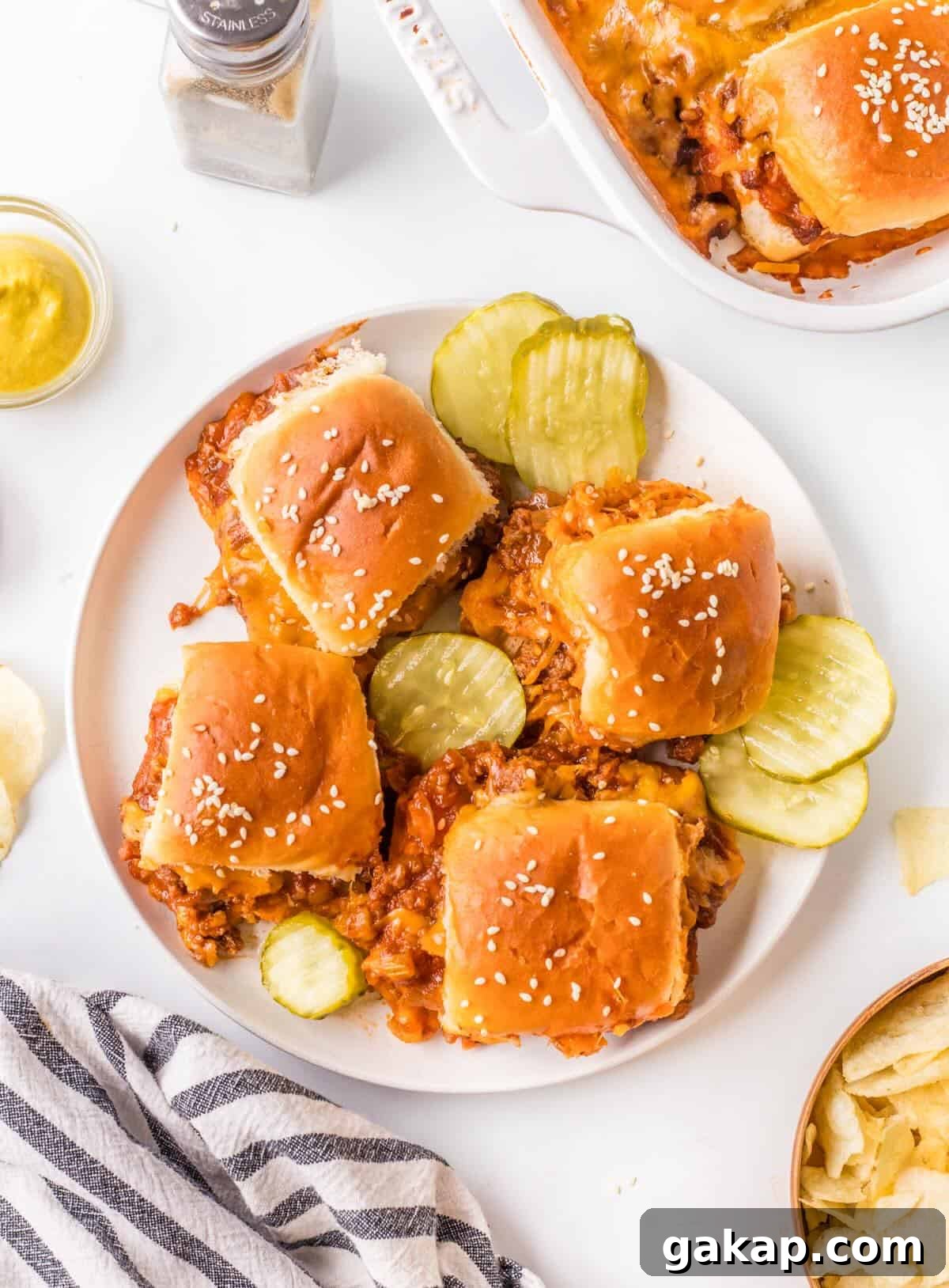 Plated sliders with potato chips and dill pickle chips.