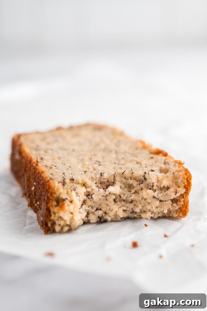 Close-up of an almond flour banana bread slice showing the soft interior and lightly crisp crust.