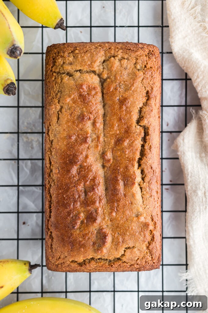Almond flour banana bread slice on a cooling rack showing the soft crumb and golden-brown crust.