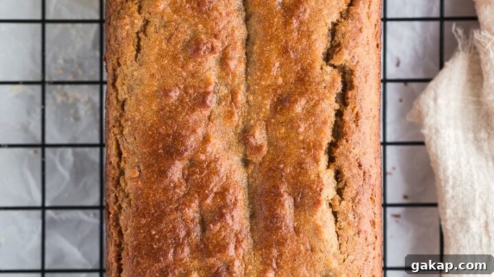 Banana almond flour bread slice cooling on rack showing soft crumb texture.