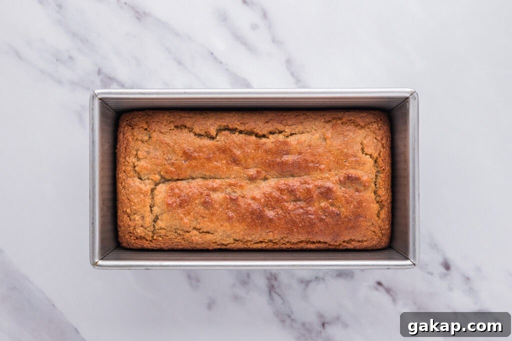 Golden brown almond flour banana bread baked in a loaf pan fresh from the oven.