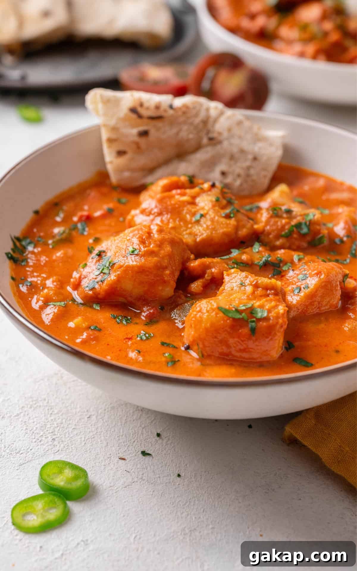 Fish curry served with pita bread.
