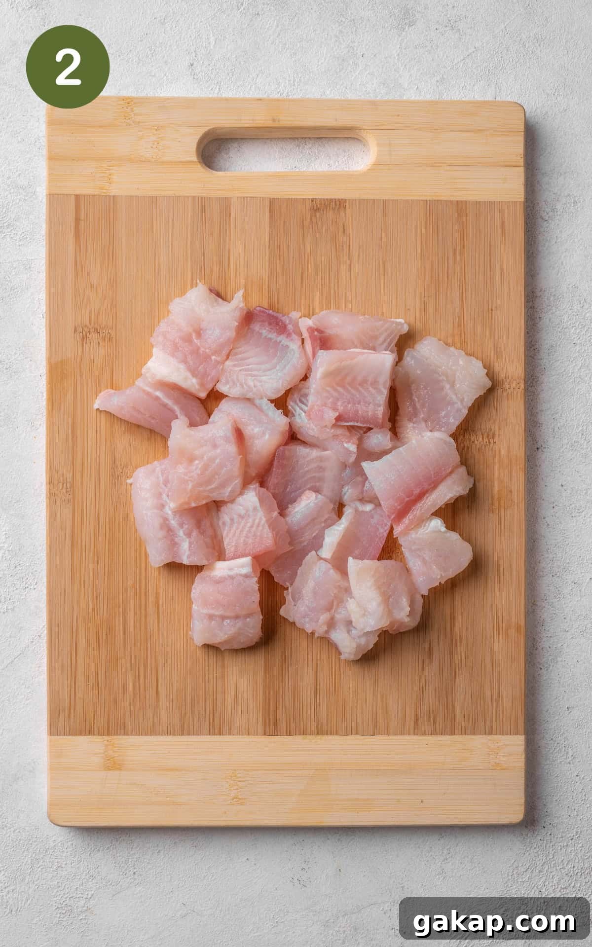 Chopped fish on a cutting board.