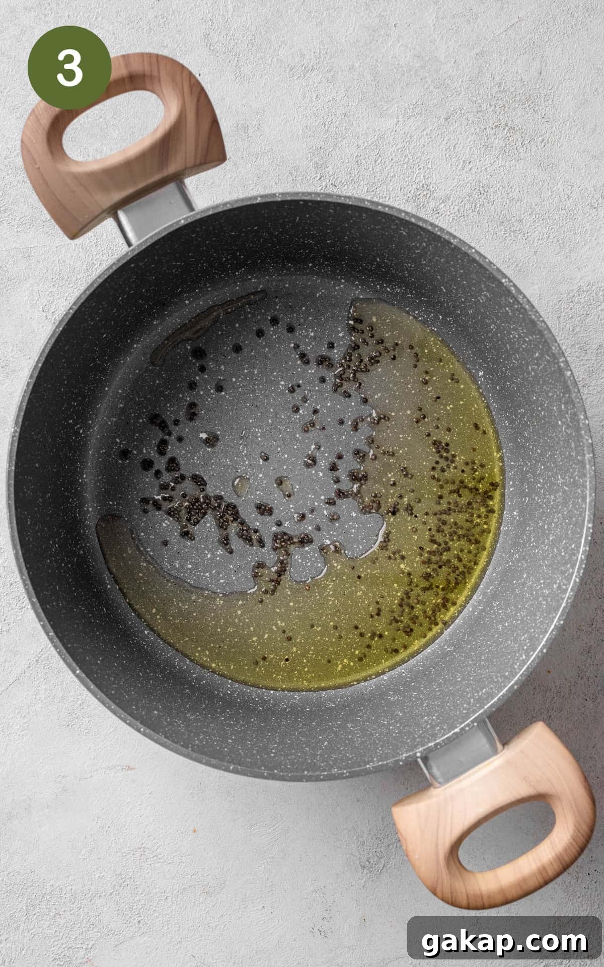 Oil and spices in a pan.