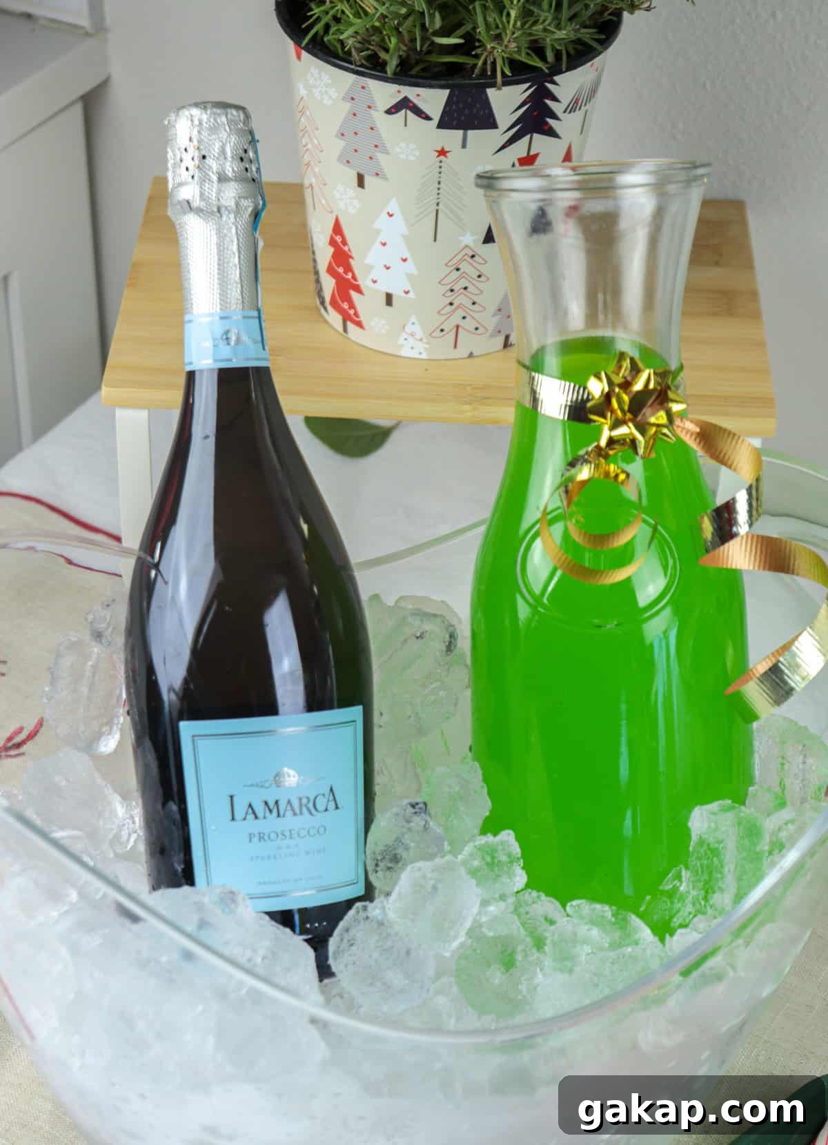 Green Grinch Mimosa Cocktail Recipe for Holiday Brunch 3 Prosecco and green juice in carafes over ice.