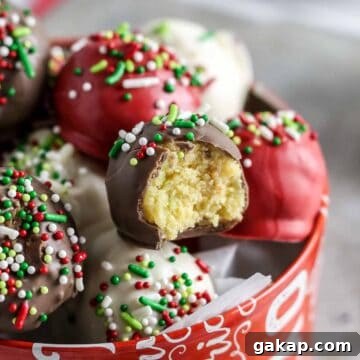 Christmas cake balls in stacked an aluminum tin.