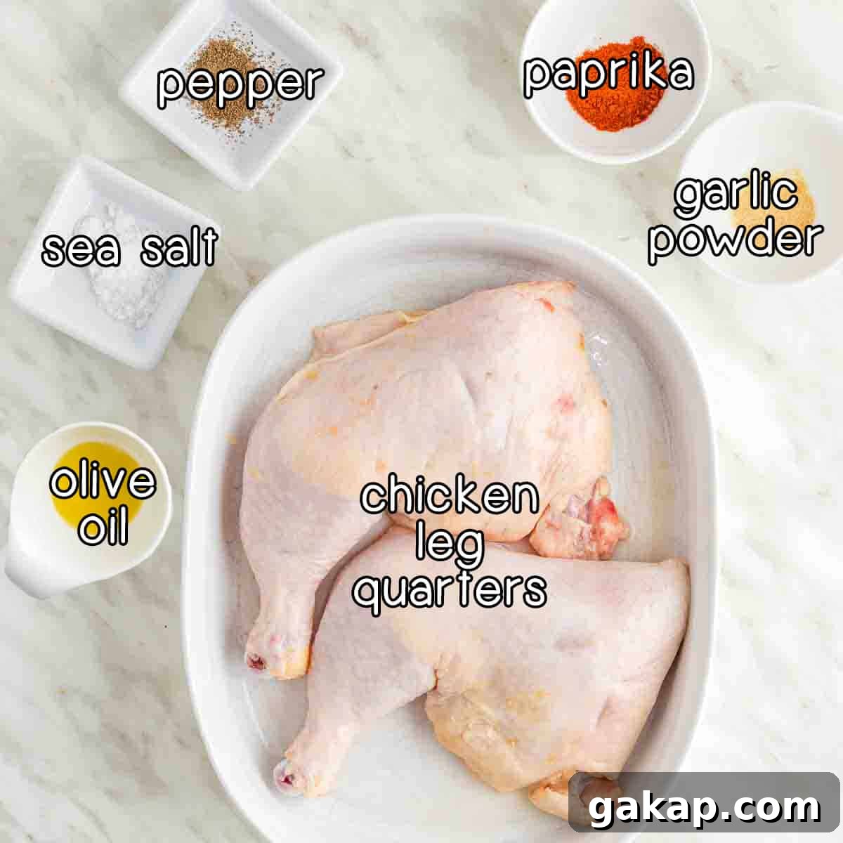Crispy Air Fryer Chicken Leg Quarters with Garlic Herb Rub 3 Overhead shot of ingredients - chicken leg quarters, olive oil, sea salt, pepper, paprika, and garlic powder.