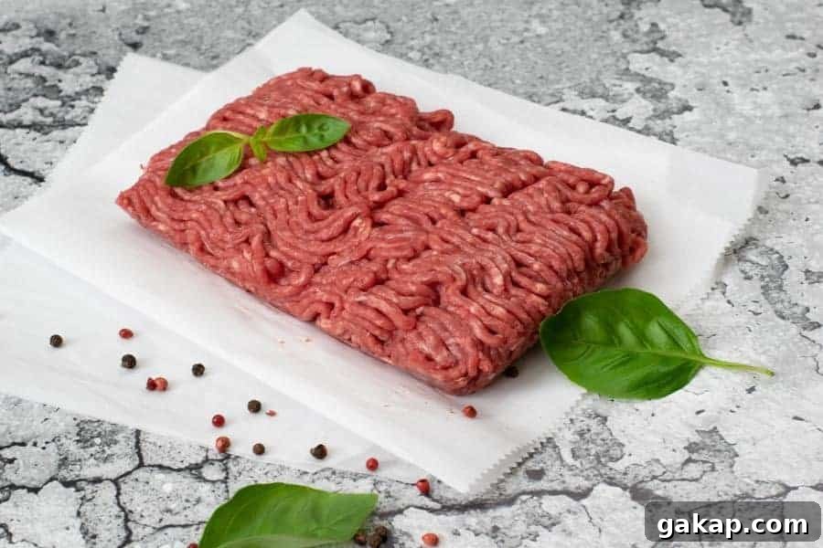 Spicy Fiery Ground Beef Jerky Recipe 3 Ground Beef with basil on parchment paper and marble