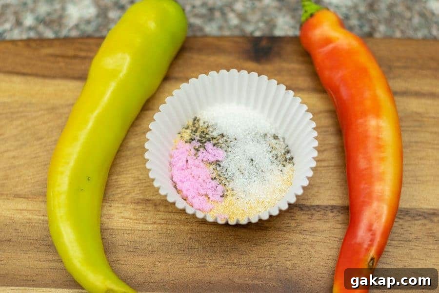Spicy Fiery Ground Beef Jerky Recipe 4 Ingredients for spicy jerky in dish with two banana peppers surrounding it on a cutting board