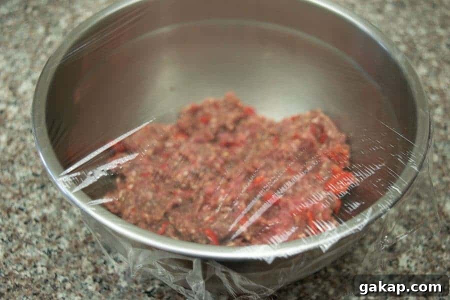 Spicy Fiery Ground Beef Jerky Recipe 8 Wicked fiery ground beef jerky in bowl with plastic wrap over bowl
