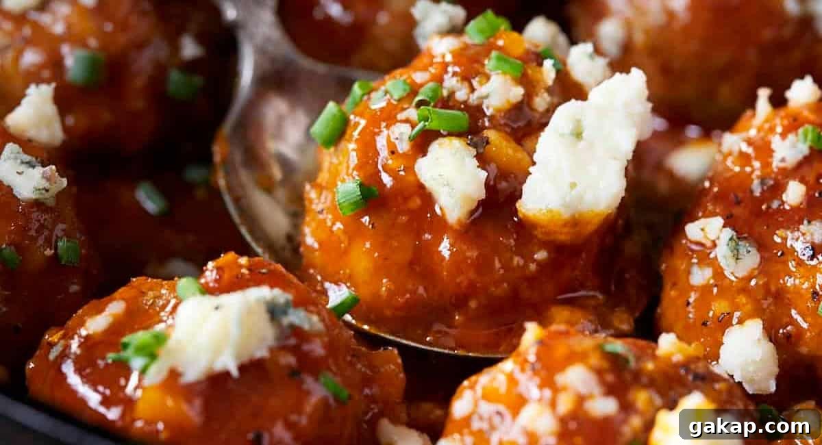 Up close image of buffalo chicken meatballs with honey garlic buffalo sauce. 