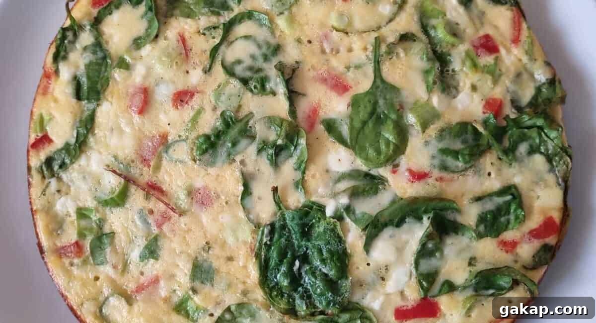 Overhead image of crustless cottage cheese quiche on white dish. 