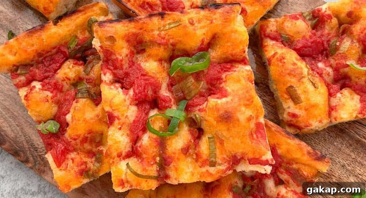 Overhead up close image of ligurian focaccia on wooden board. 