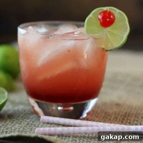 A cocktail on a dark background with title text overlay for Pinterest.