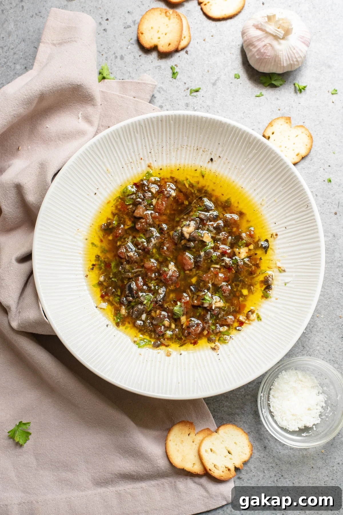An overhead image of olive oil bread dip on a serving plate.