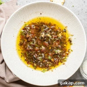An overhead image of olive oil bread dip on a serving plate.