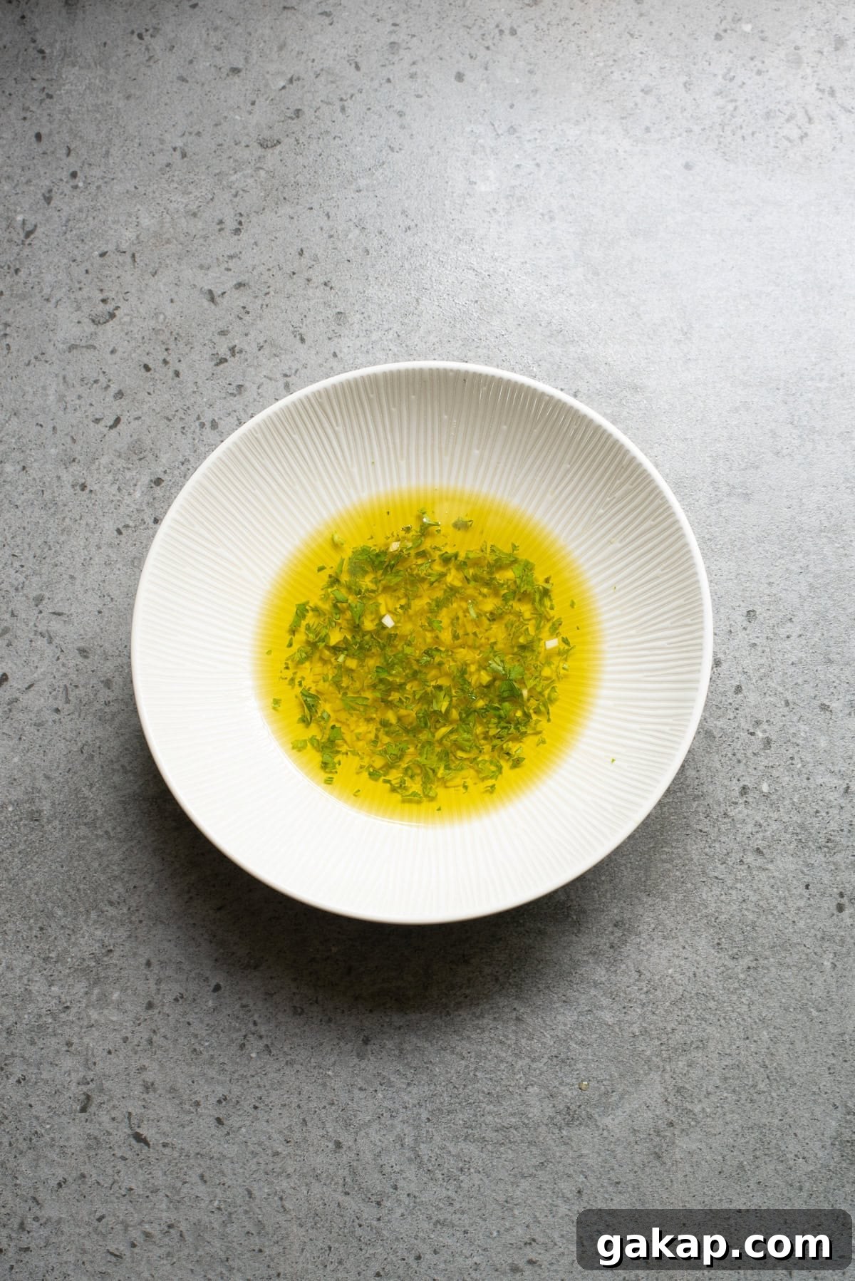 An overhead image of olive oil in a shallow dish.