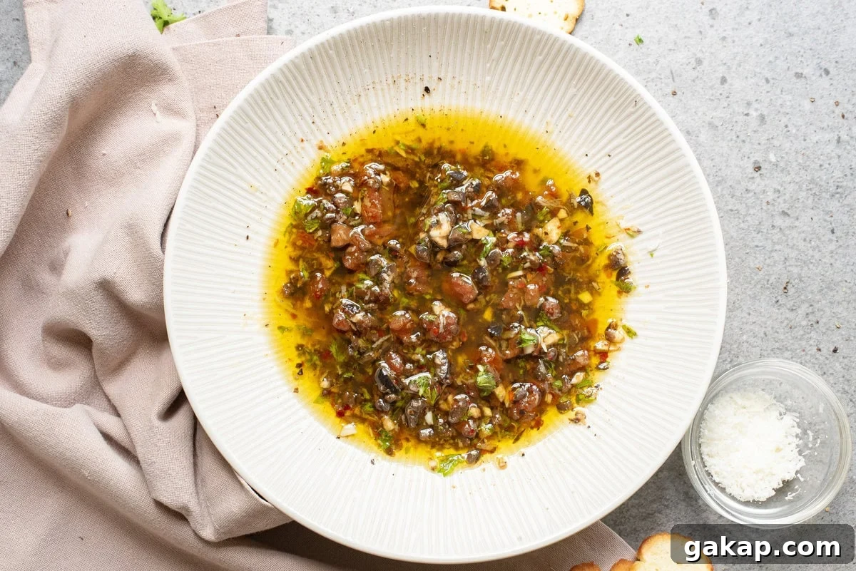 An overhead image of olive oil dipping oil on a serving plate.