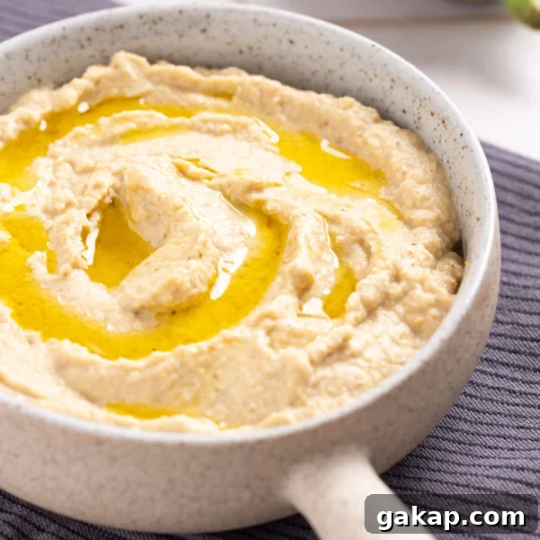 An image of eggplant hummus served n a small saucepan.