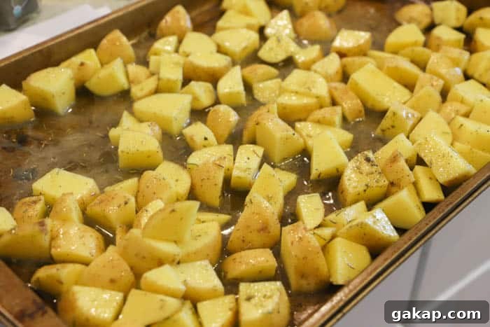Crispy Lemon-Herb Roasted Potatoes for Weeknight Meals 5 adding potatoes to the sheet pan