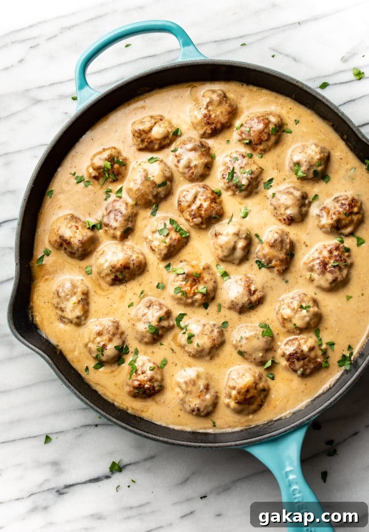 Classic Swedish Meatballs Recipe: Creamy Sauce & Lingonberry Pairing 2 Swedish meatballs in a skillet