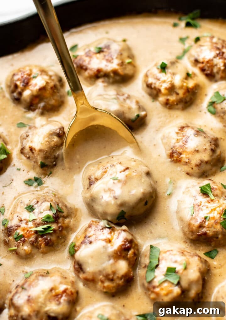 Classic Swedish Meatballs Recipe: Creamy Sauce & Lingonberry Pairing 8 close-up of a spoon with a swedish meatballs over a skillet