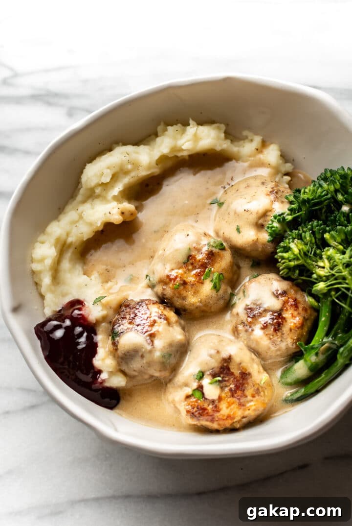 Classic Swedish Meatballs Recipe: Creamy Sauce & Lingonberry Pairing 9 a bowl with mashed potatoes, broccolini, lingonberry sauce, and swedish meatballs