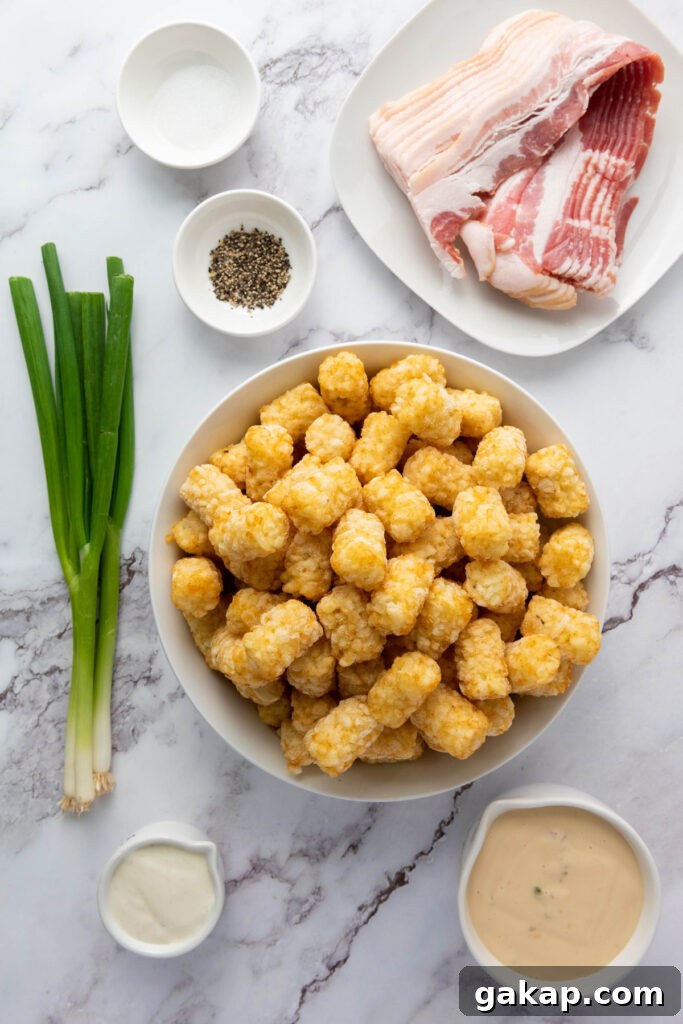 Loaded Tater Tots Recipe: Crispy, Cheesy Potato Bites 3 loaded tater tots ingredients in bowls on marble counter
