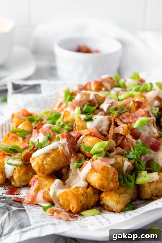 Loaded Tater Tots Recipe: Crispy, Cheesy Potato Bites 7 loaded tater tots on paper lined platter