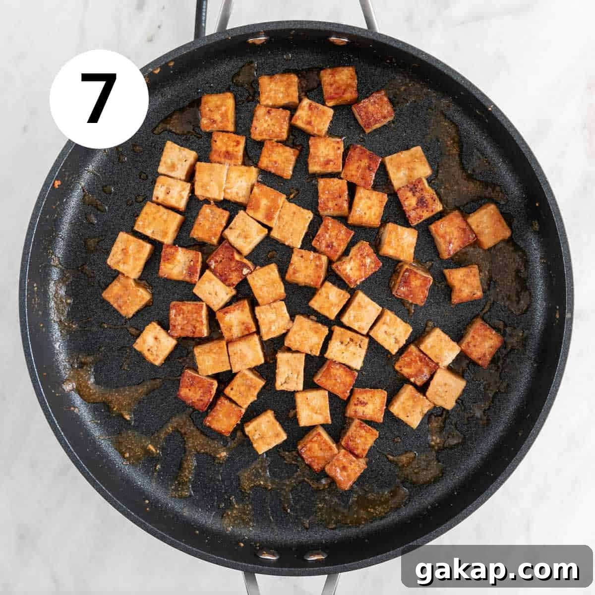 Marinated tofu cooked in a skillet.