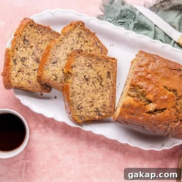 High protein banana nut bread on a platter served with coffee.