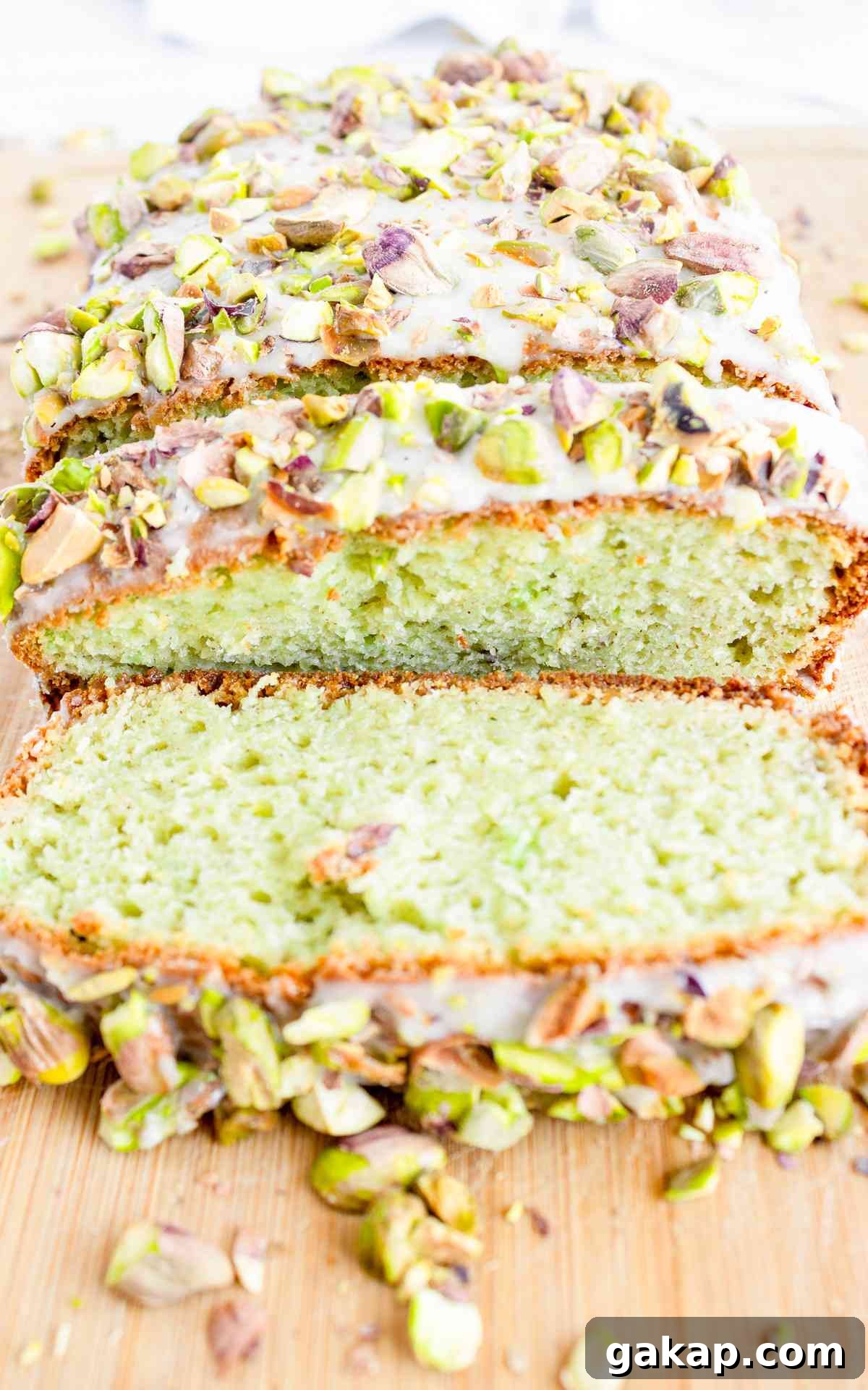 Pistachio Quick Bread Recipe: Moist Loaf with Crunchy Nuts 2 Sliced pistachio bread glazed with sweet almond icing and crushed pistachios.