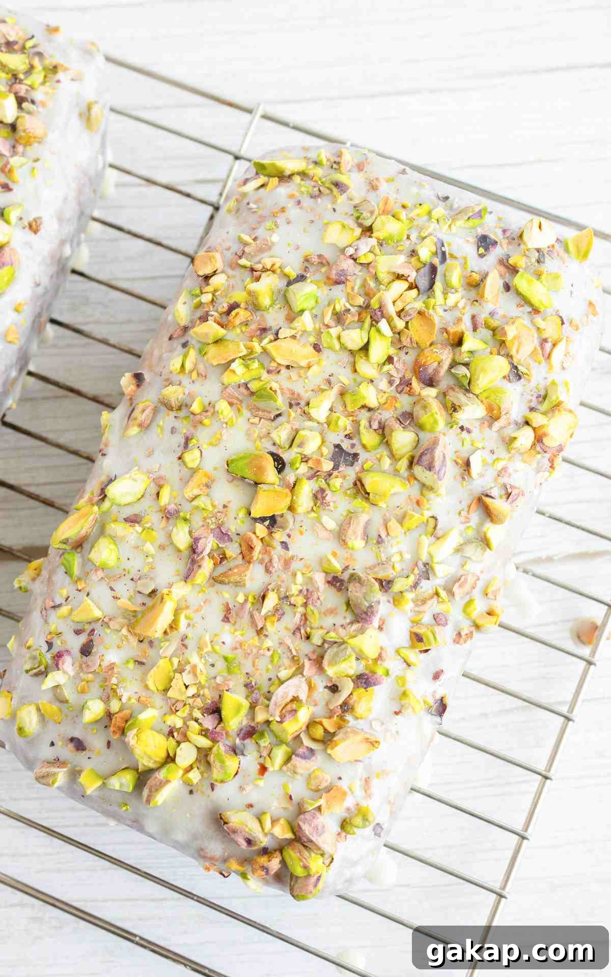 Pistachio Quick Bread Recipe: Moist Loaf with Crunchy Nuts 5 Overhead view of pistachio bread on wire rack.