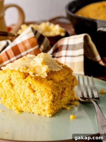 Honey butter smeared on top of a slice of sweet potato cornbread.
