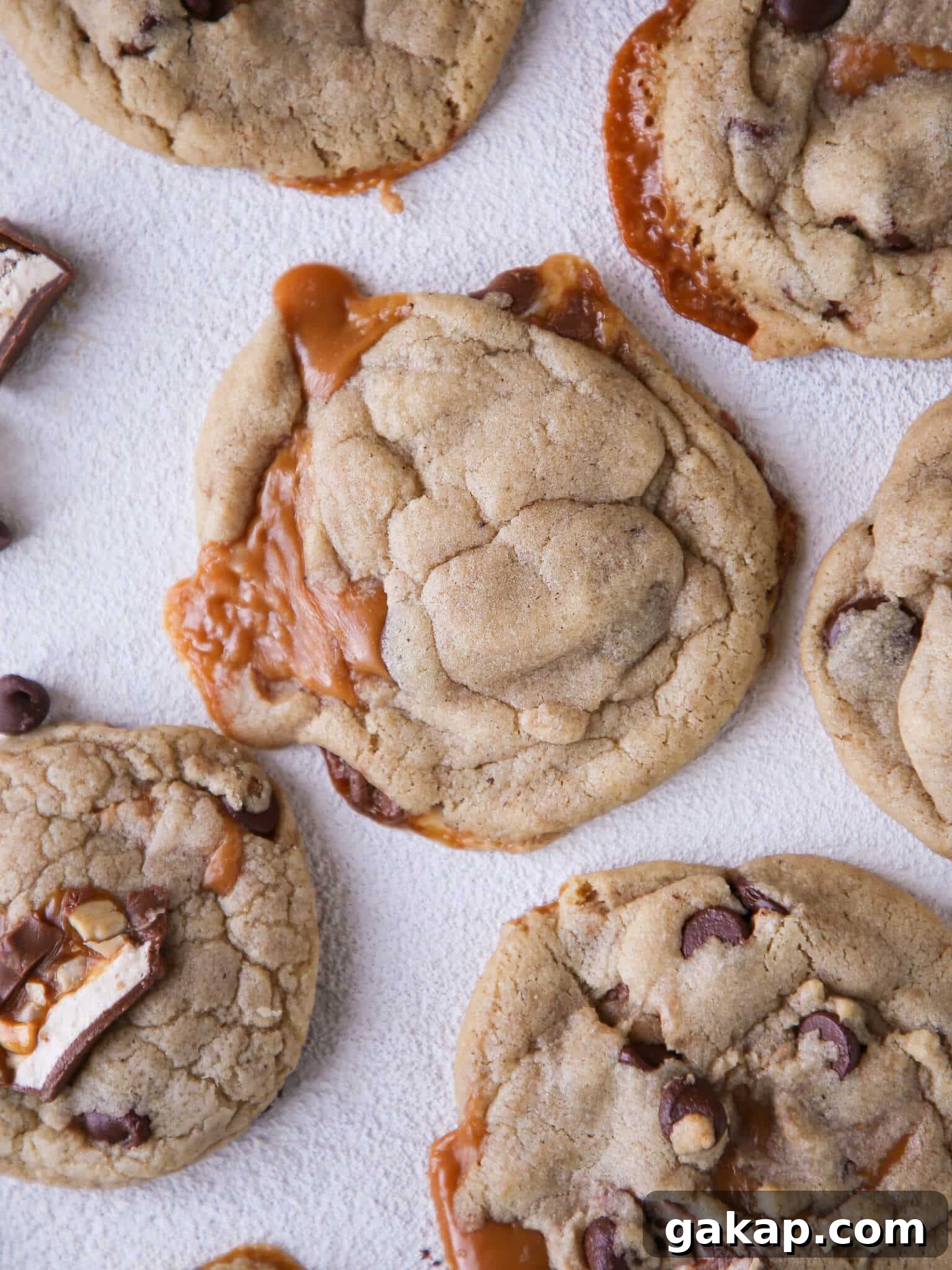 Brown Butter Snickers Caramel-Stuffed Chocolate Chip Cookies 5 Caramel Stuffed Brown Butter Snickers Chocolate Chip Cookies with caramel spilling out