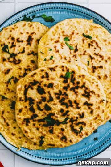 Overhead shot of homemade chickpea flatbread on a blue plate.
