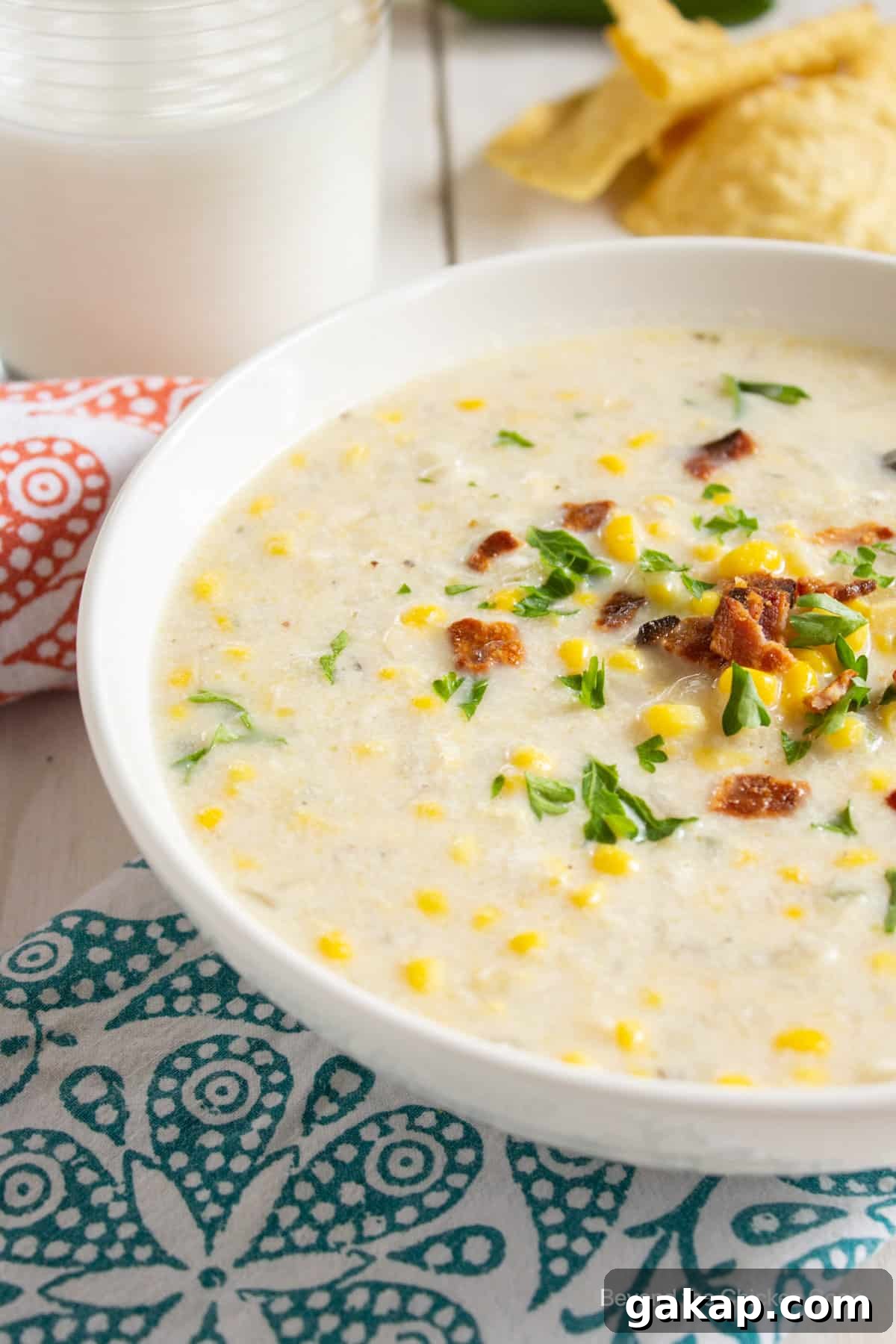 A creamy soup with corn and bacon and green herbs.