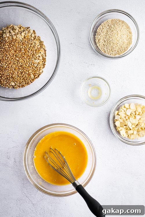 Tahini Sesame Granola with Honey and Orange Zest 4 A top down view of the ingredients for tahini granola with orange and honey.
