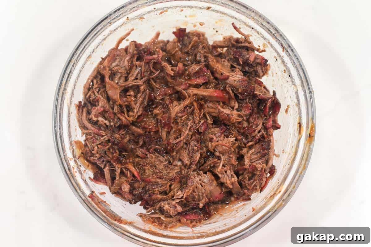process shots of tossing pulled beef in BBQ sauce