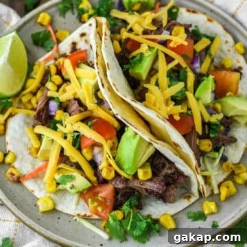 two smoked pulled beef tacos on plate