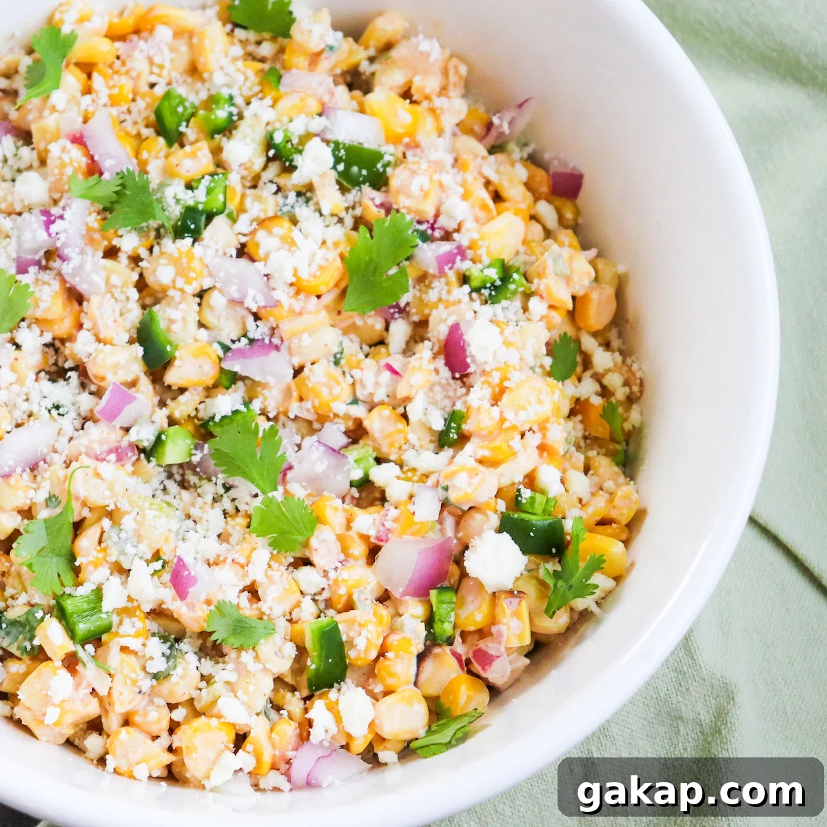 grilled corn, cotija cheese, red onion and cilantro in a bowl
