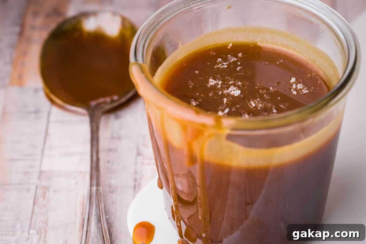 salted caramel sauce in glass jar, drizzling down jar.