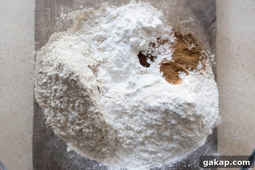 Flour mix for Cinnamon Apple Cake with Salted Caramel Cream Cheese Buttercream in a glass bowl