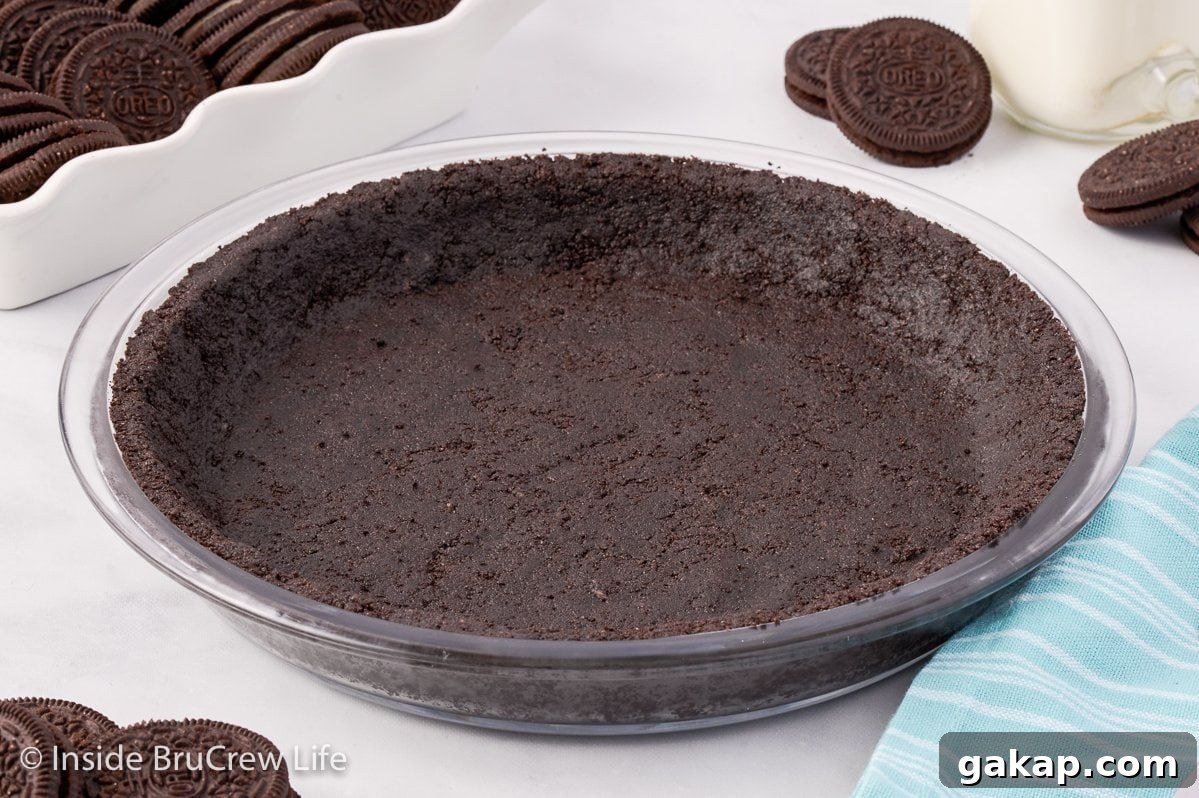 A chocolate cookie crust on a white board.