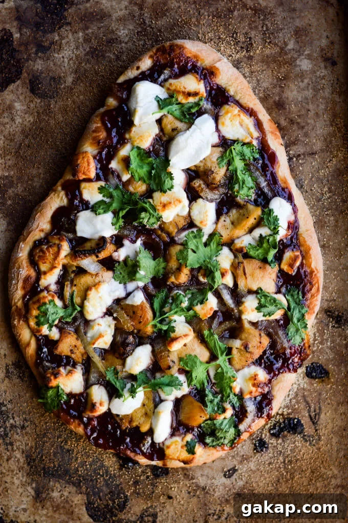 Crispy-Chewy Homemade Pizza Dough Recipe for Perfect Crust 10 A cooked pizza with raspberry jalapeno sauce, chicken, caramelized onions, goat cheese and cilantro.