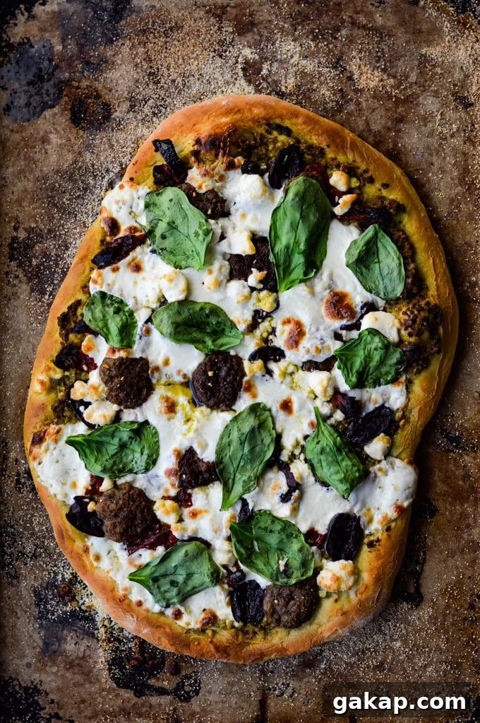 Crispy-Chewy Homemade Pizza Dough Recipe for Perfect Crust 9 A cooked mediterranean pizza with lamb, feta, mozzarella, kalamata olives and sundried tomatoes.