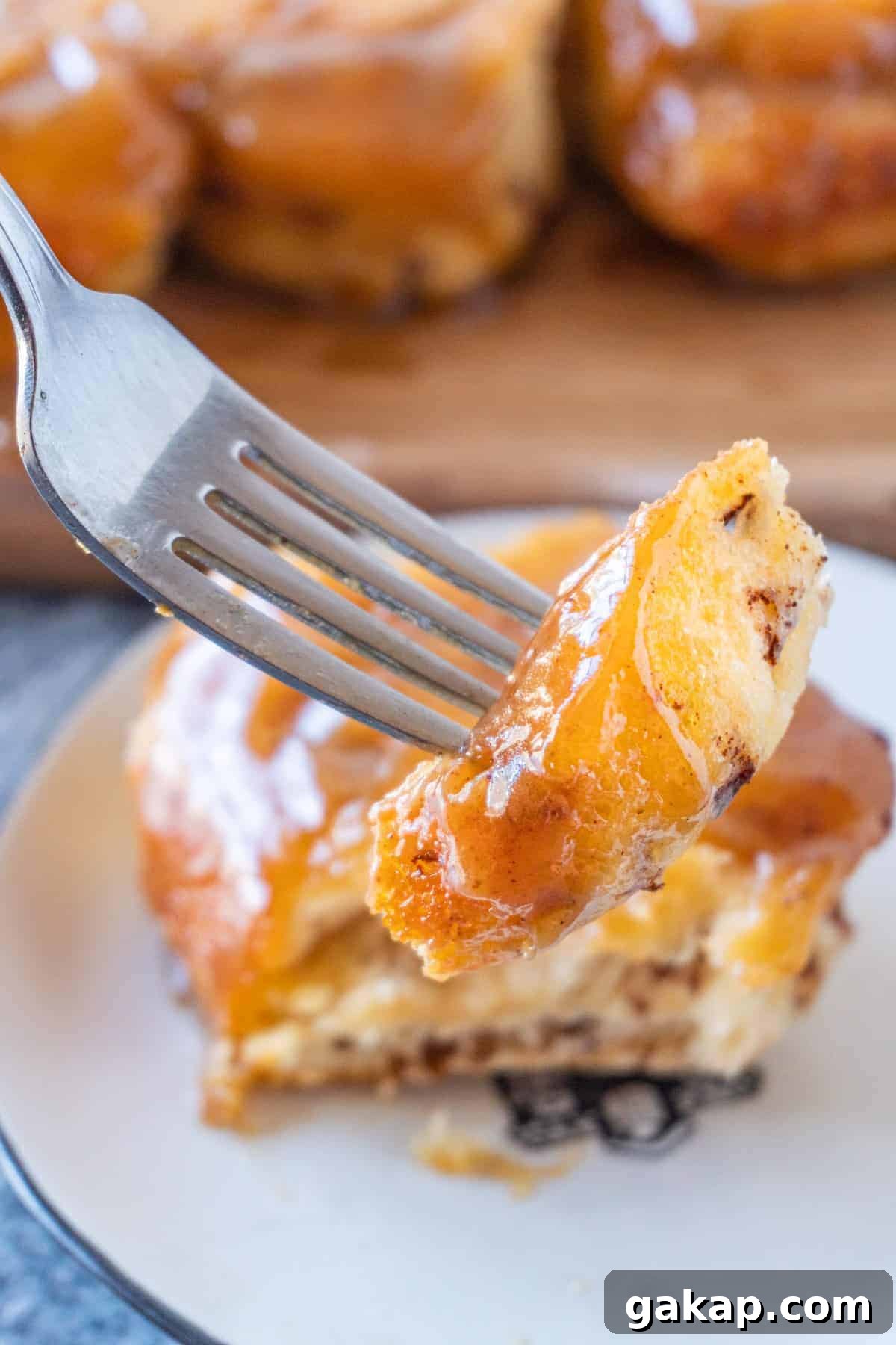 Sticky Caramel Cinnamon Rolls with Gooey Glaze 3 Piece of sticky bun on fork